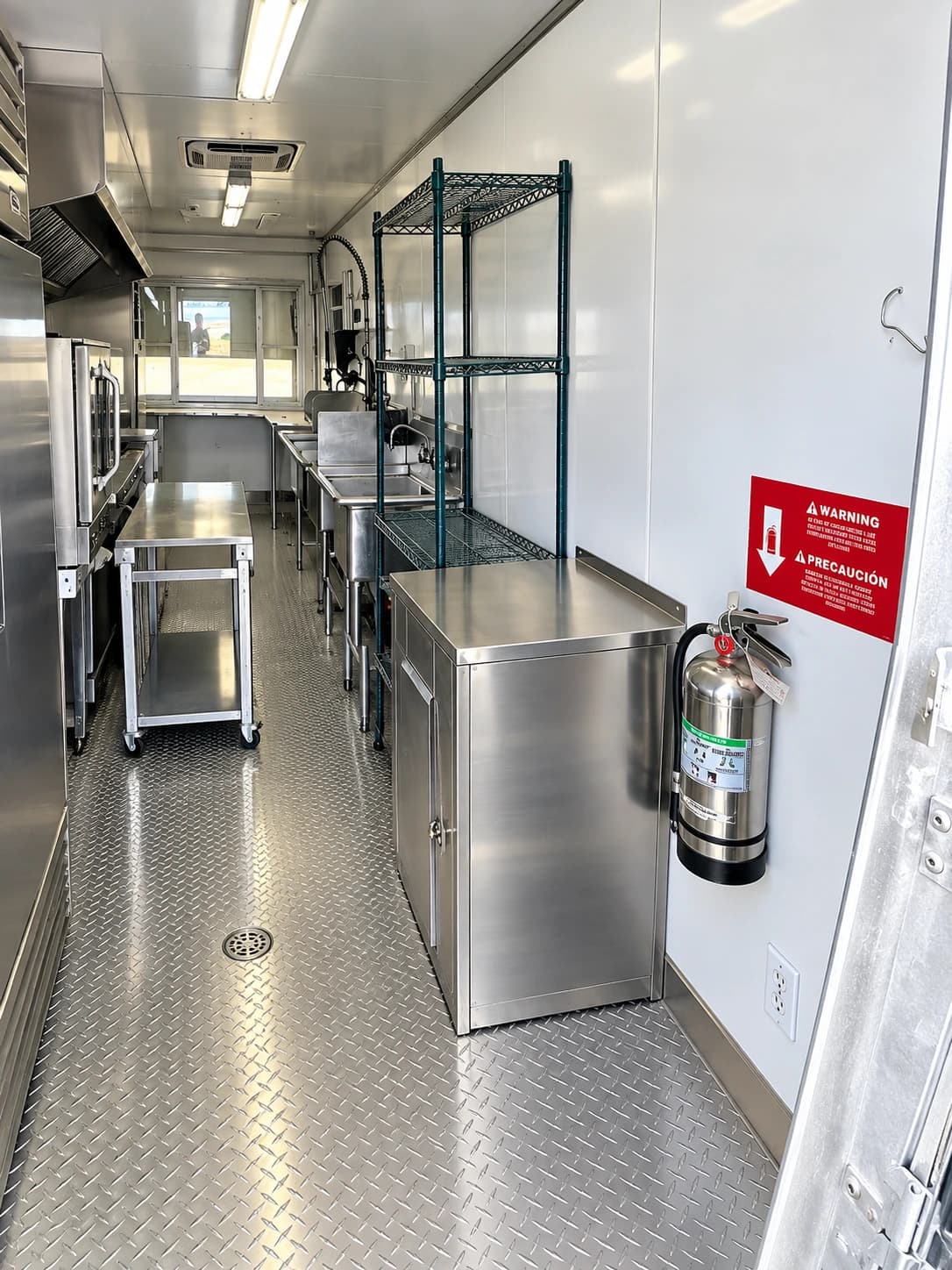 24 ft mobile kitchen trailer interior with range, ovens and prep area